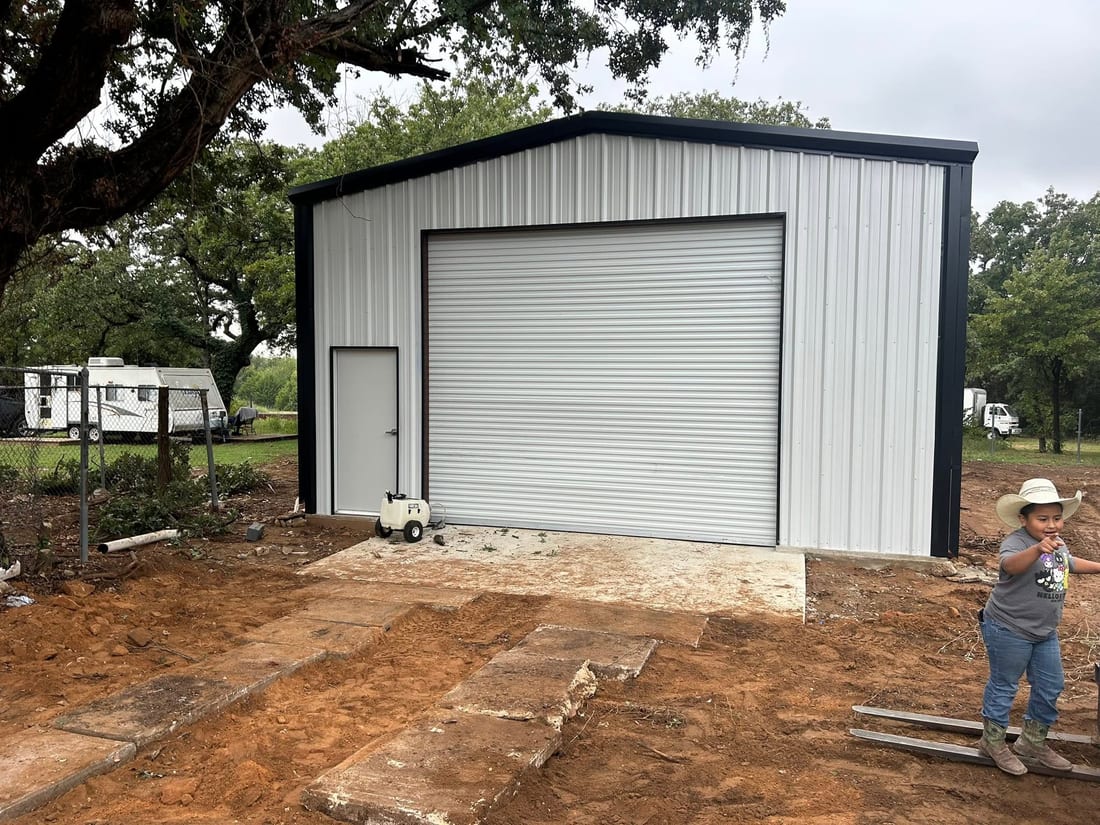 Enclosed metal building with roll-up doors