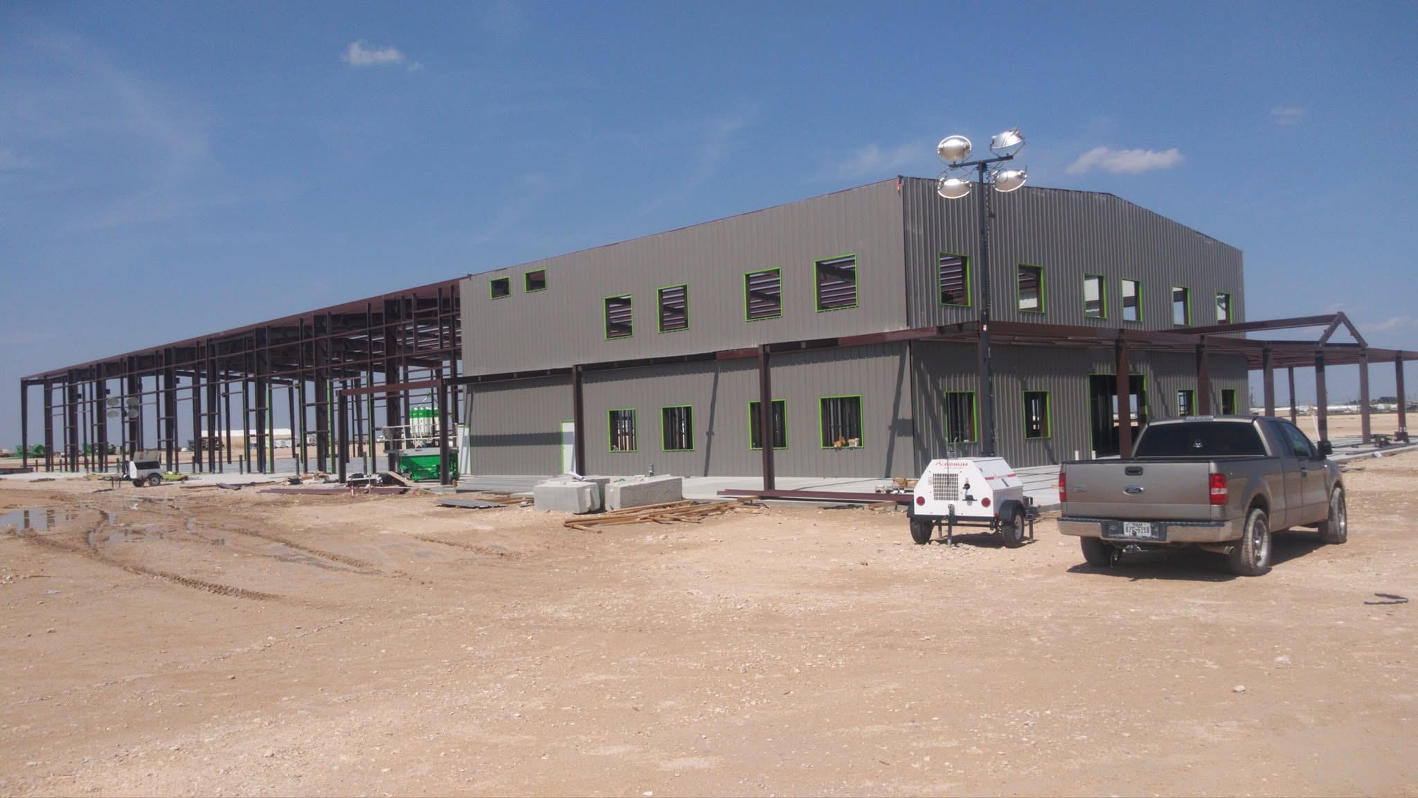 Two-story gray commercial metal building under construction