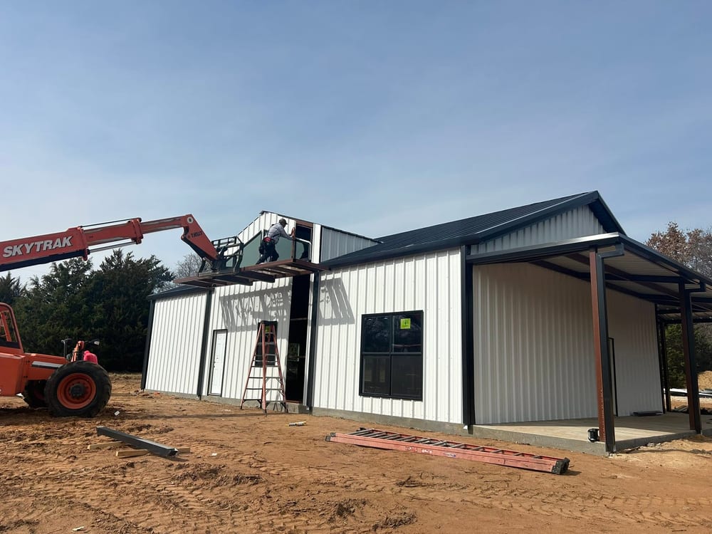 White metal shop with a side awning under construction